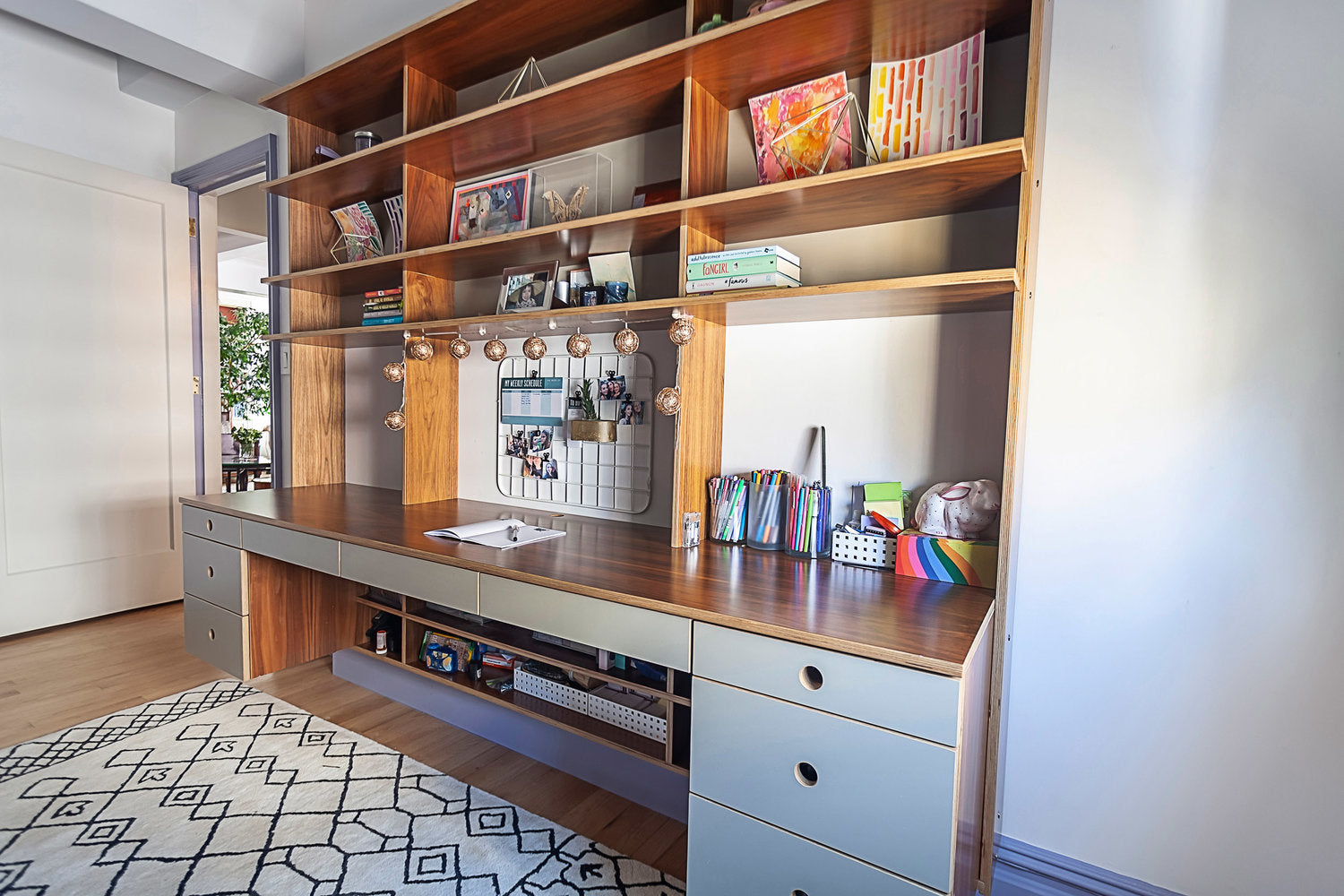 Bookshelf with books, decor, and a white bowl on a cabinet