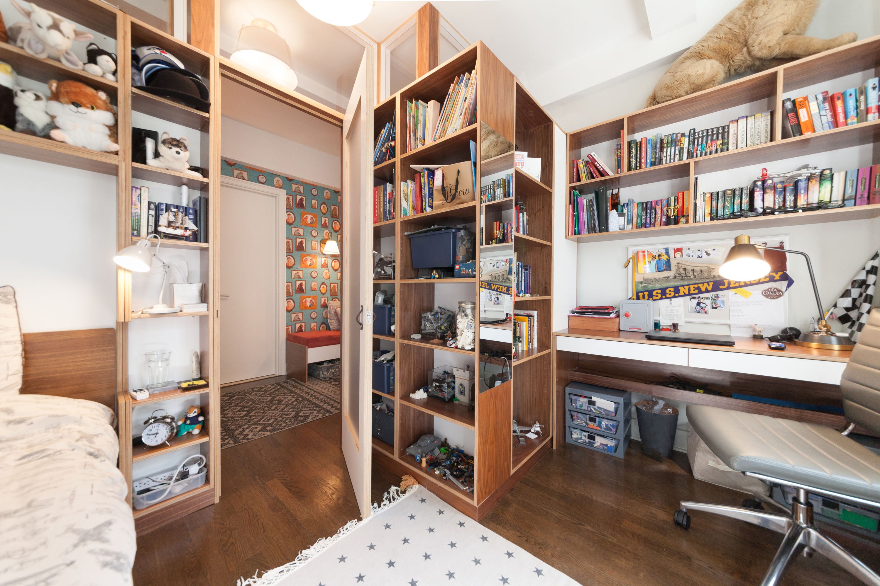 Bedroom with study area, bookshelves, bed with star bedding.