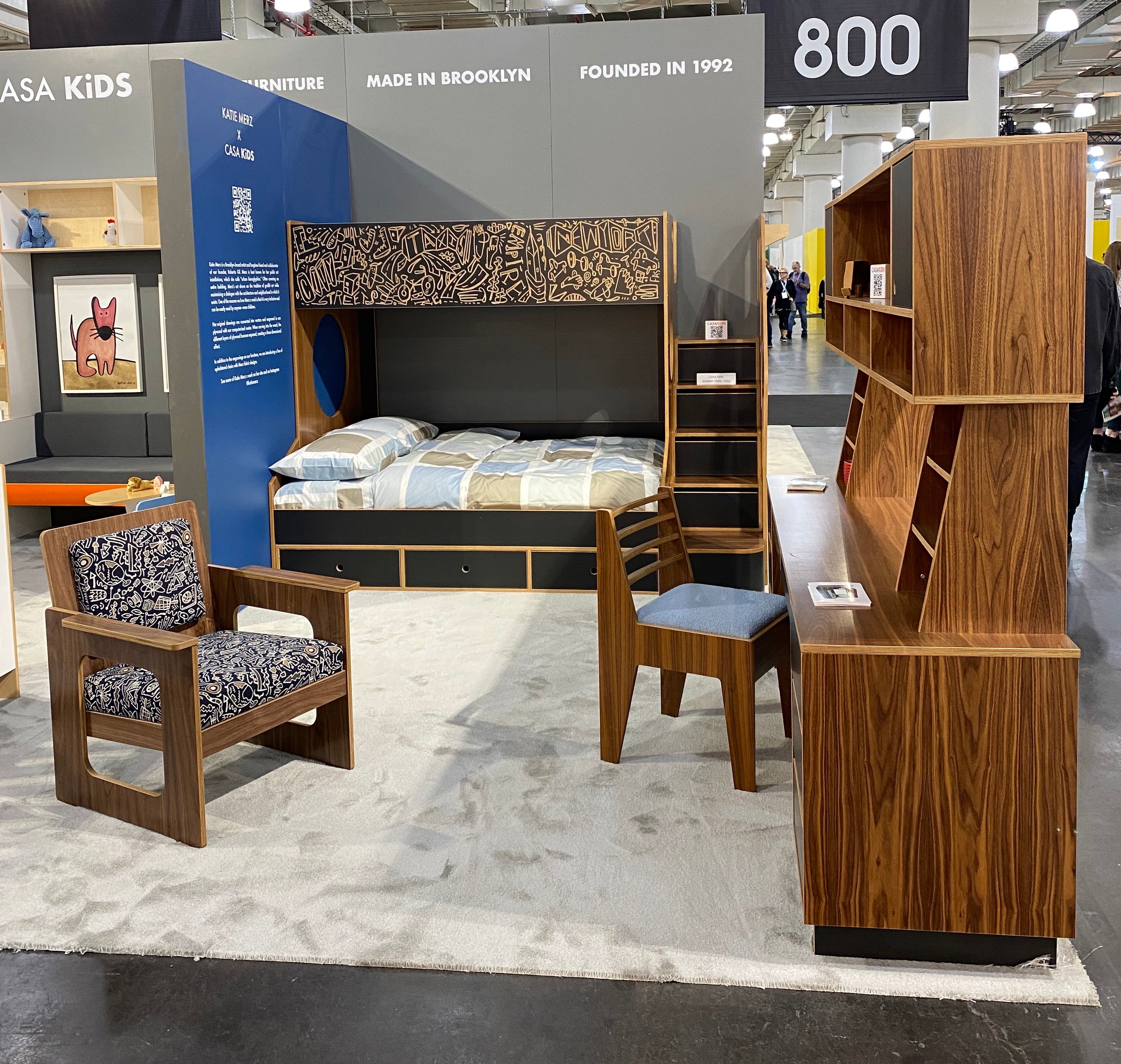 Casa Kids furniture display featuring a patterned bed, matching chair, stool, and a spiraling shelf.