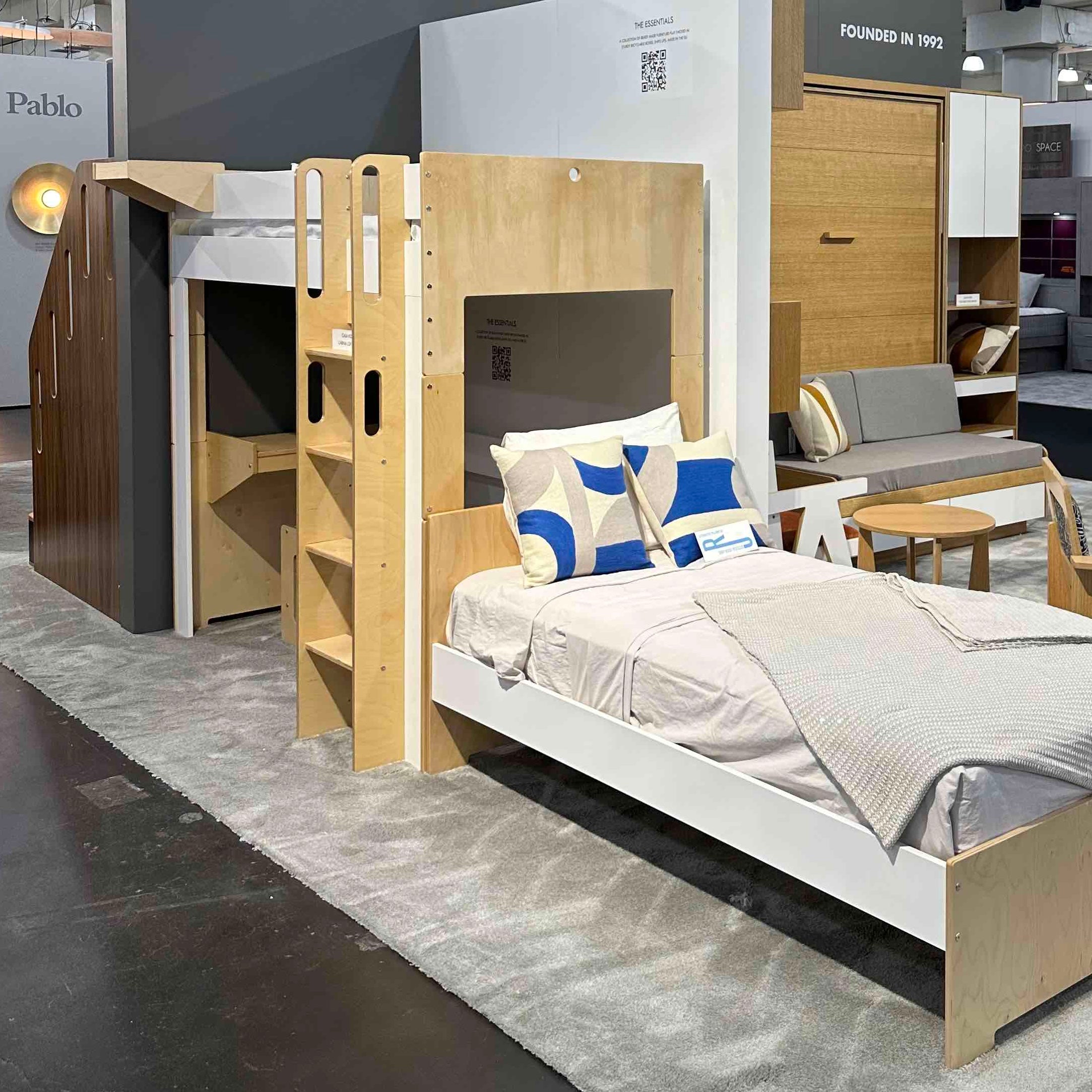 Showcase of modern kids' bedroom furniture with a bed, loft setup, and playful design elements