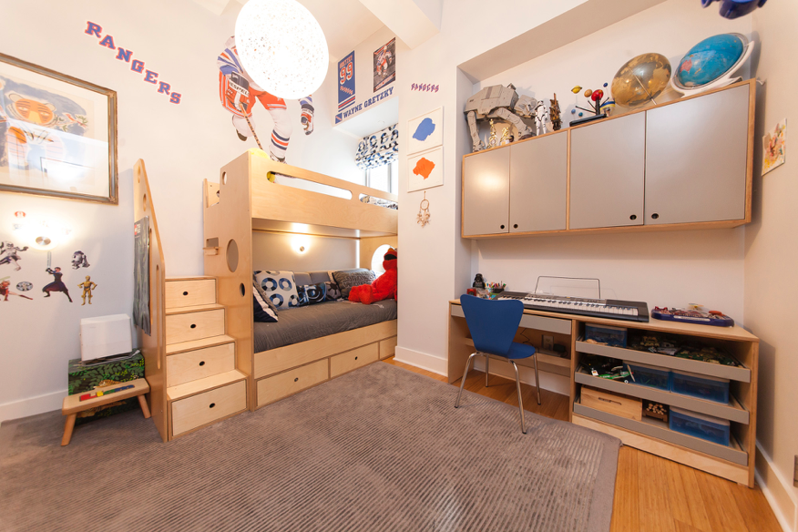 Child’s bedroom with space-themed bunk bed and toys.