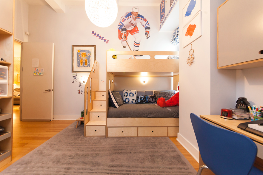 Cozy child’s bedroom with bunk bed, study area, and sports theme
