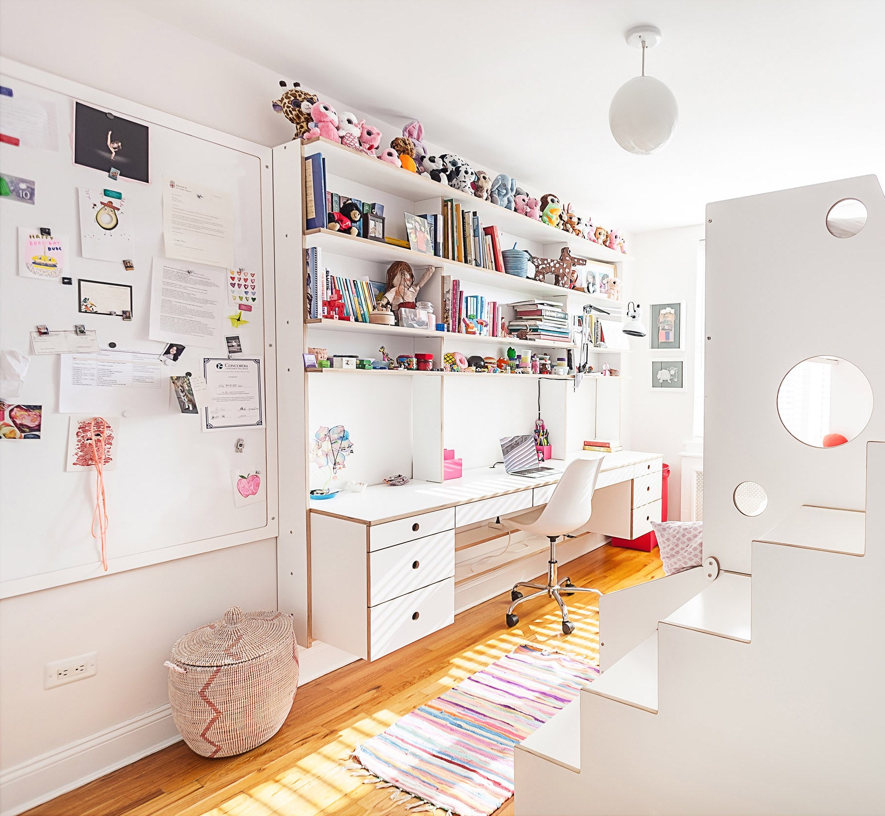 Bright home office, white furniture, colorful decor.