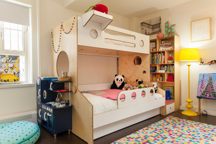Colorful children's bedroom with a bunk bed, lots of plush toys, and a vibrant, patterned rug.
