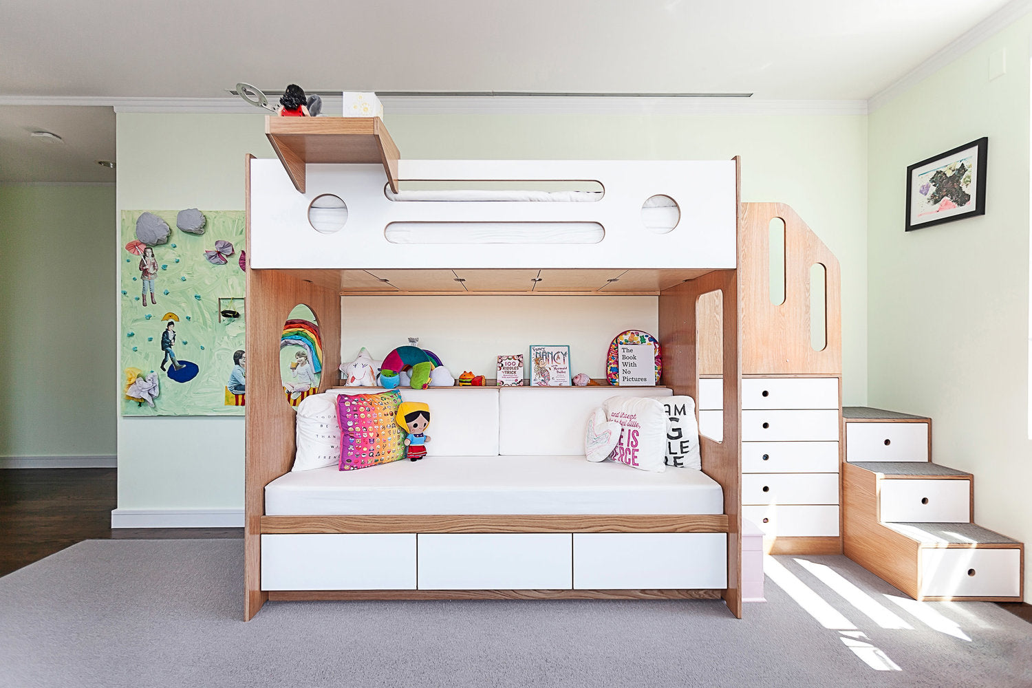 Modern kids’ room with bunk bed, storage, and colorful decor.