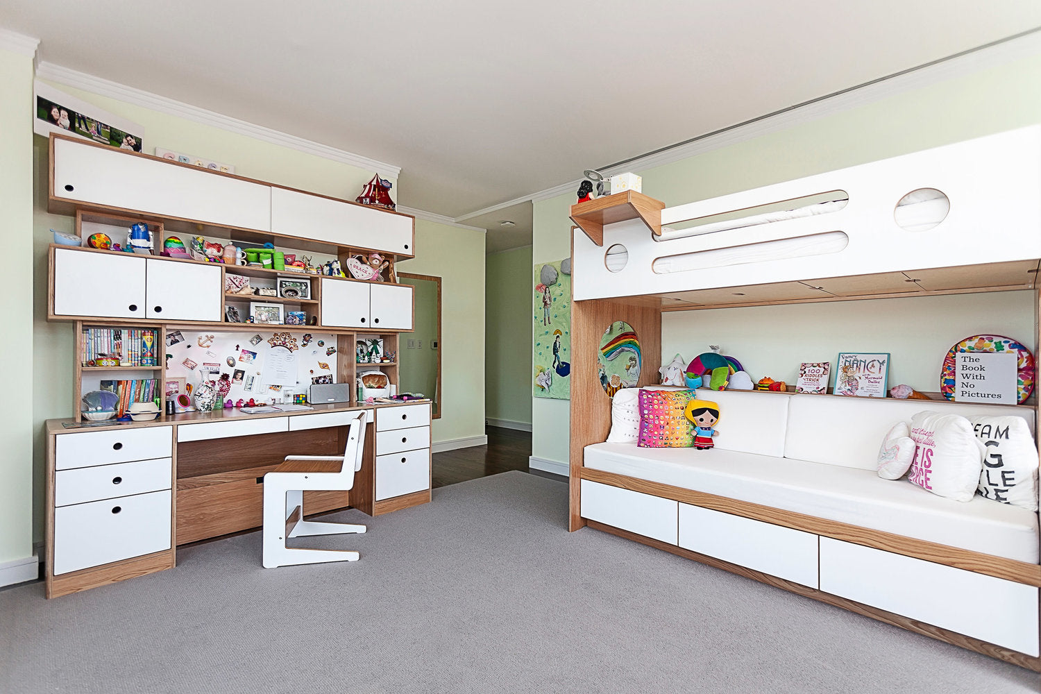 Child’s room with bunk bed, desk, shelves, and vibrant decor.
