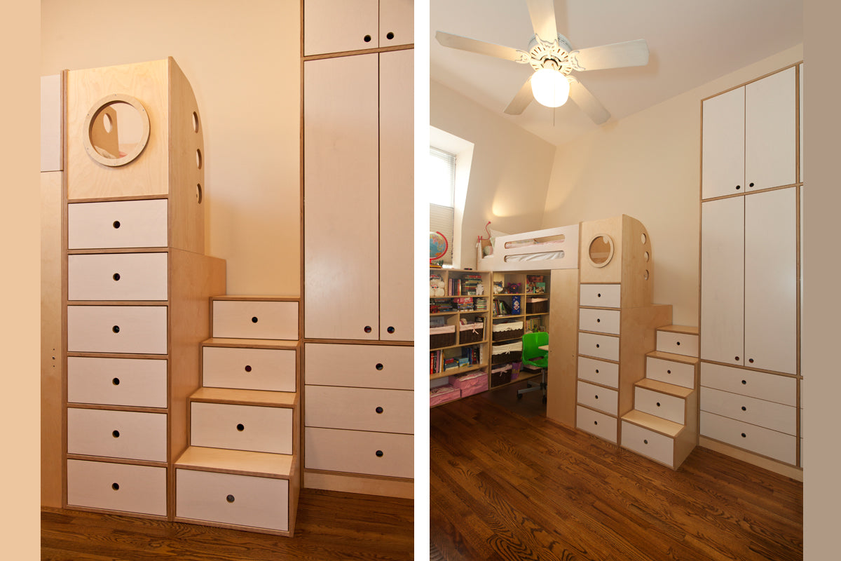 Custom wooden children’s closet with drawers, circular window, and ceiling fan in room.