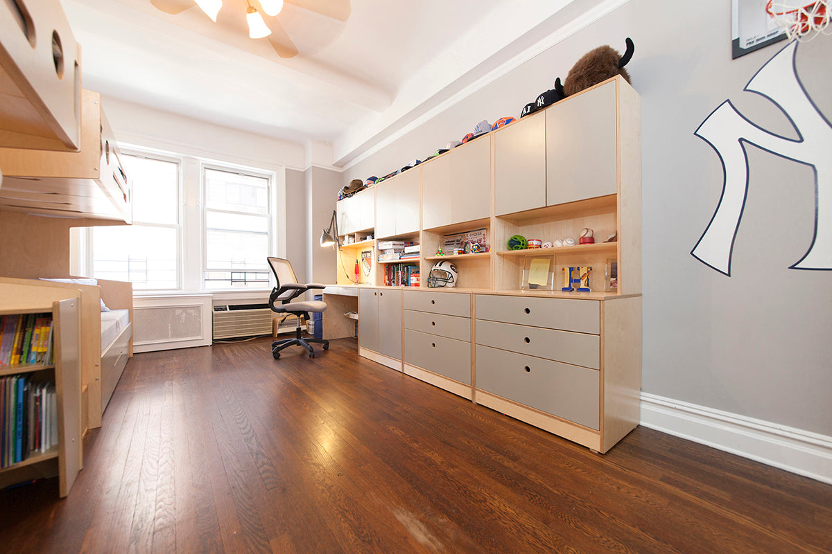 Spacious kids' room with loft bed, desk, shelving, and hardwood floor.