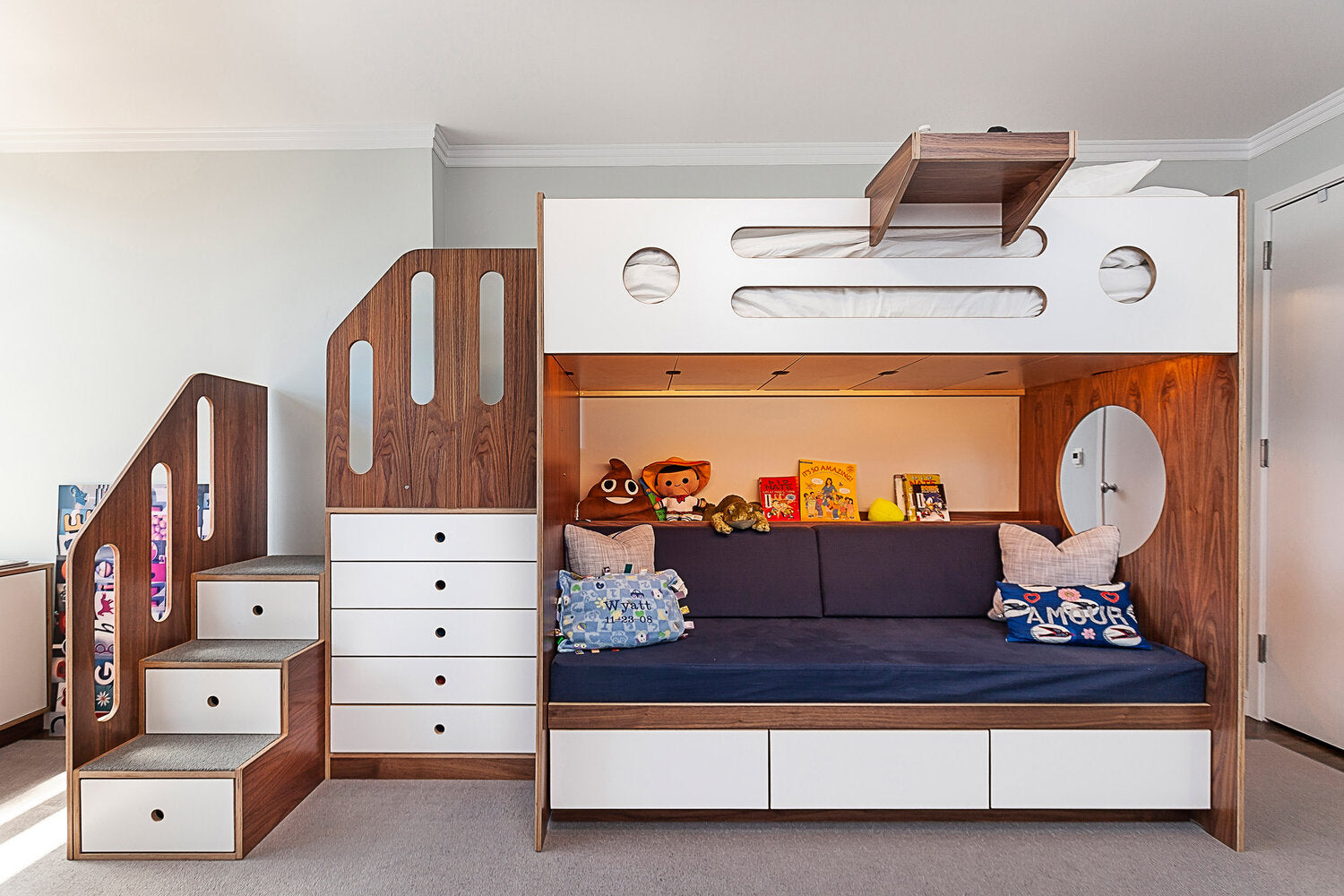 Bunk bed with stairs, drawers, play area for children’s room with ample storage.