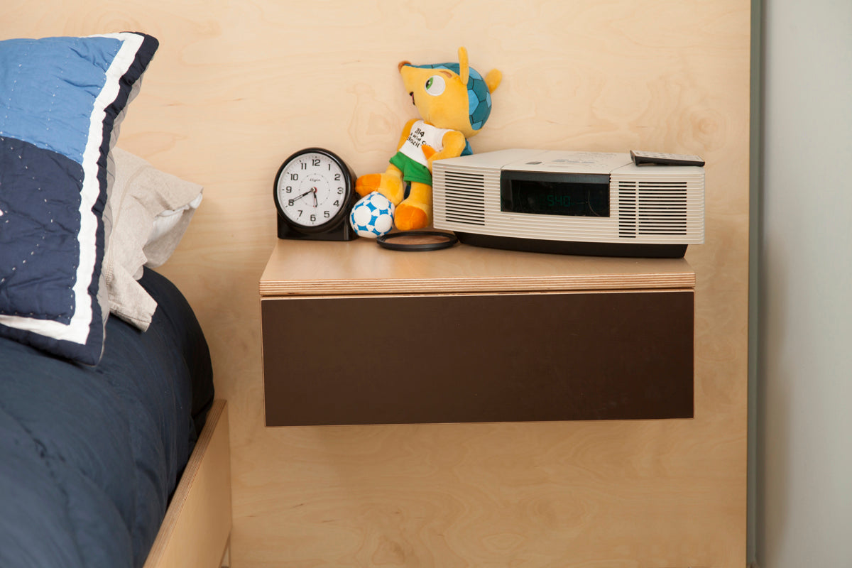 Bedroom with clock, toy, radio on nightstand.