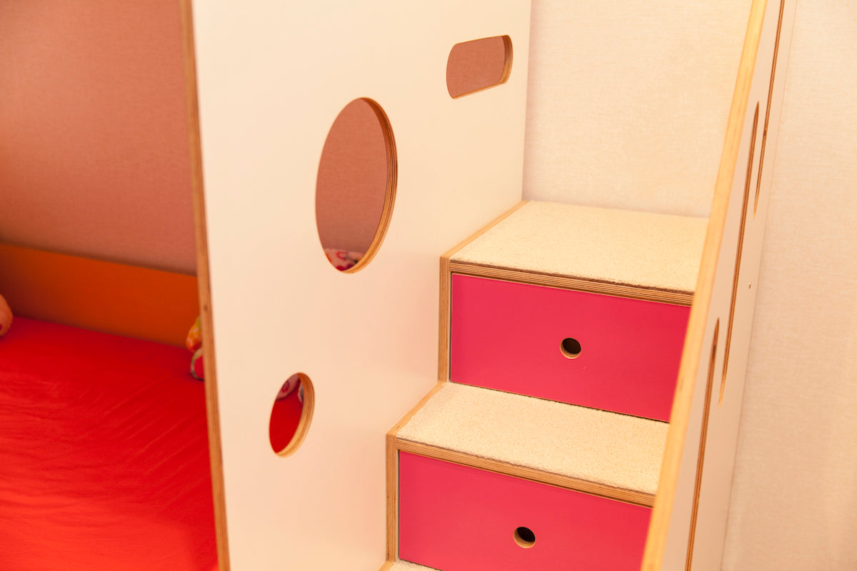 Pink playhouse drawers with circular cutouts