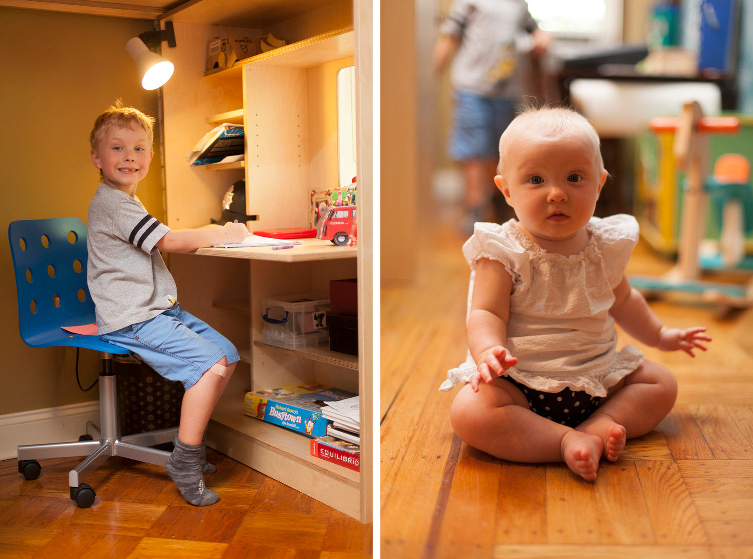 Child at desk, baby on floor, home setting, blurred background.