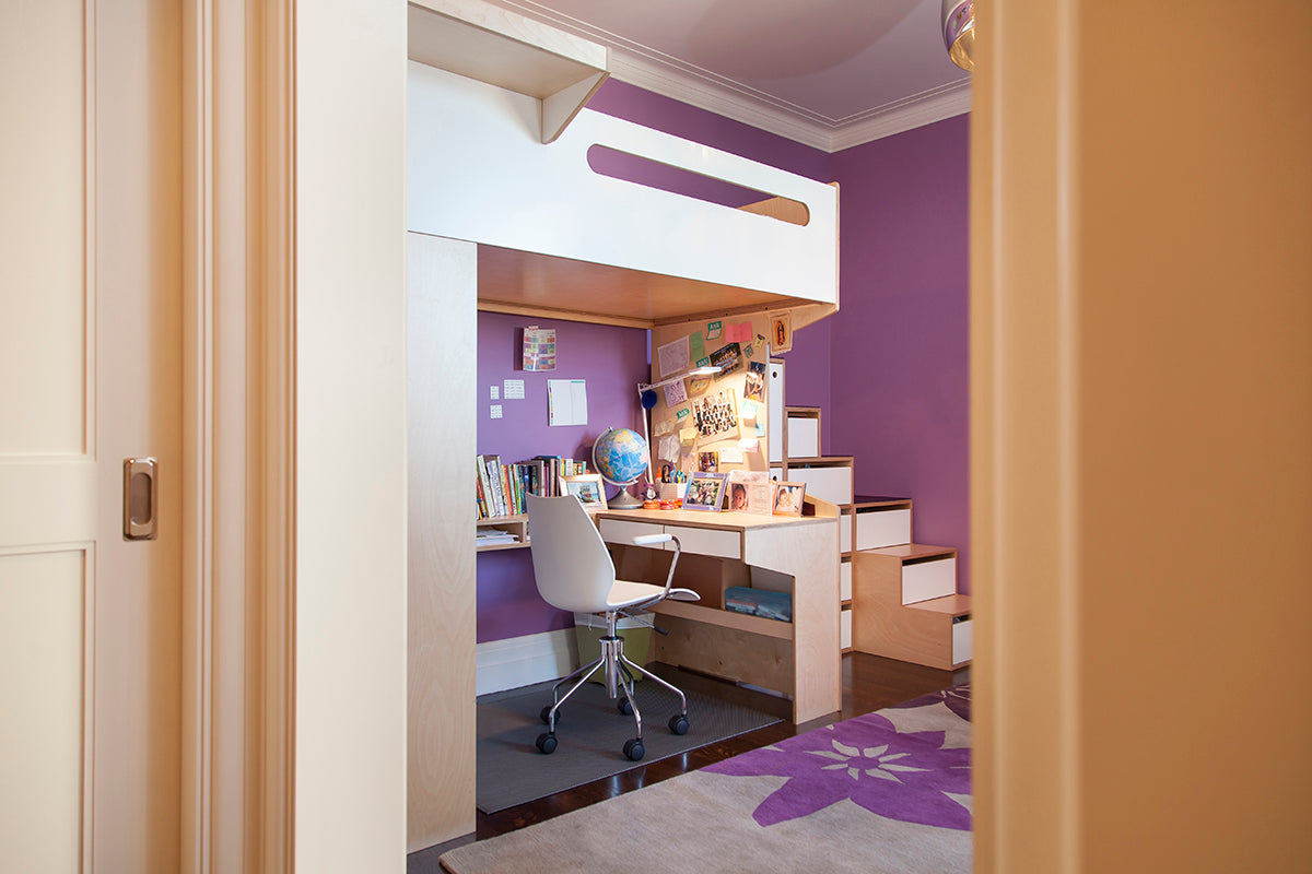 Cozy study area with desk, chair, and globe visible through an open door.