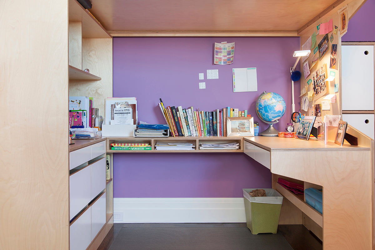 A tidy study area with desk, shelves, books, and a globe