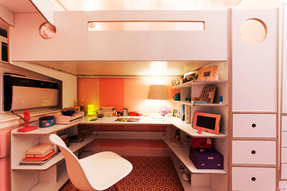 Compact home office, white desk, shelving, orange accents, efficient space utilization.