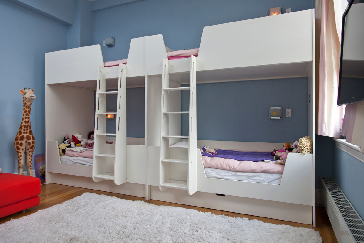 Bunk beds, ladders, toys, giraffe decor in a blue room