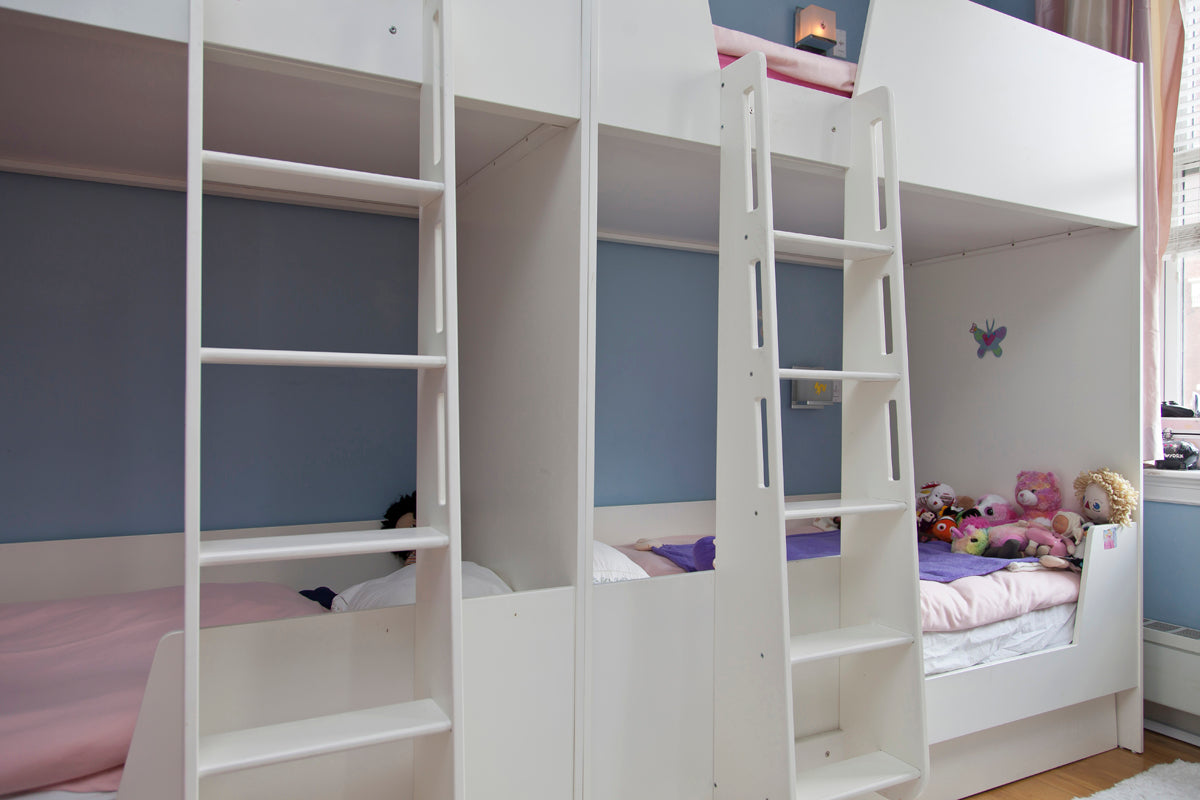 Cozy blue room with white bunk bed, ladder, and plush toys.