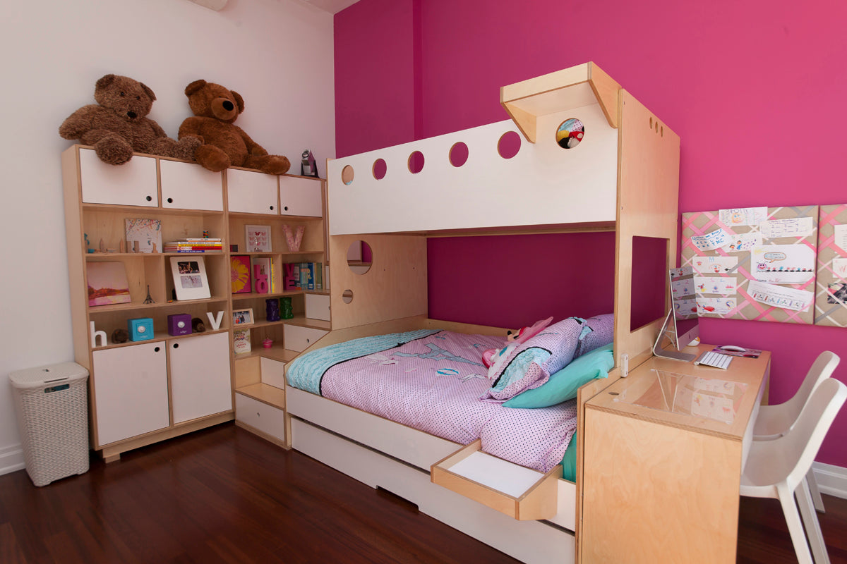 “Cozy child’s room with bunk bed, teddy bears, pink walls, and study area.”