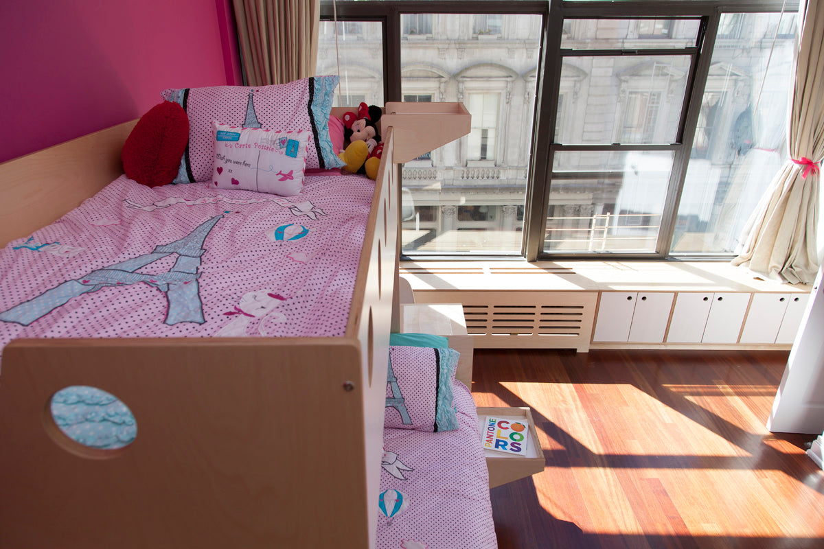 Child’s bedroom with bed, toys, and window view.