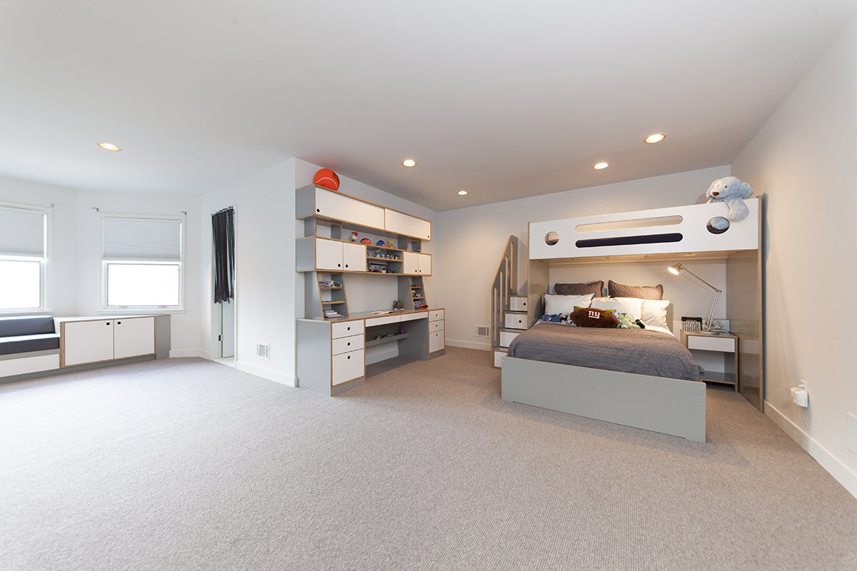 Spacious child’s bedroom with bunk bed, desk, and ample storage.