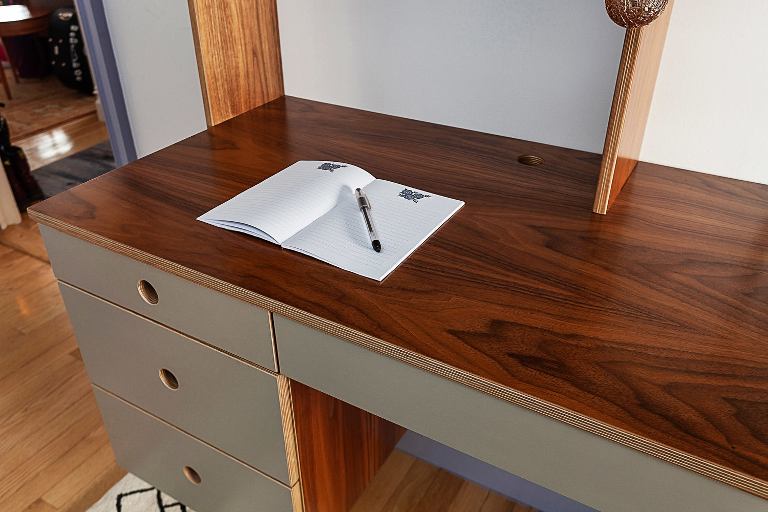 Open notebook with pen on a wooden desk, symbolizing productivity.