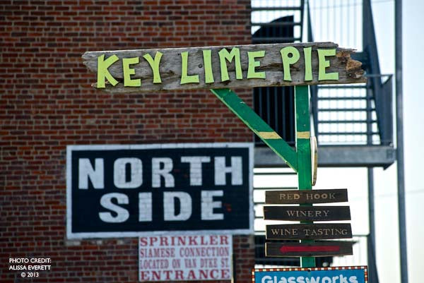 Signage ‘KEY LIME PIE’ atop ‘NORTH SIDE’ with arrows, on a building facade.