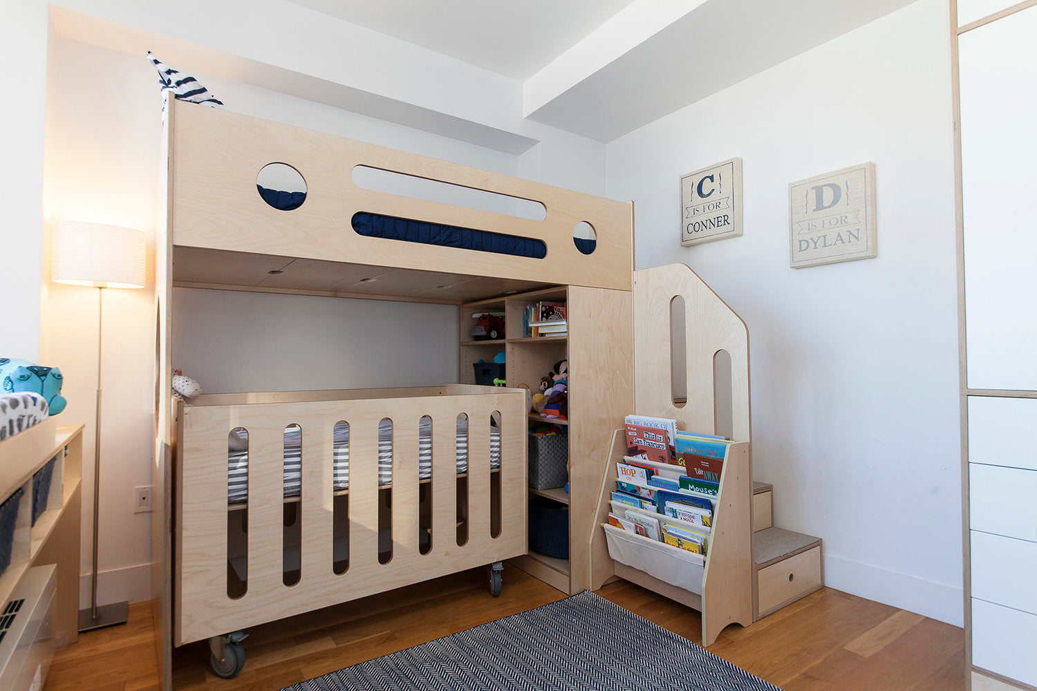 Wooden bunk bed with storage, bookshelf in child’s room named ‘Connor’ and ‘Dylan’.