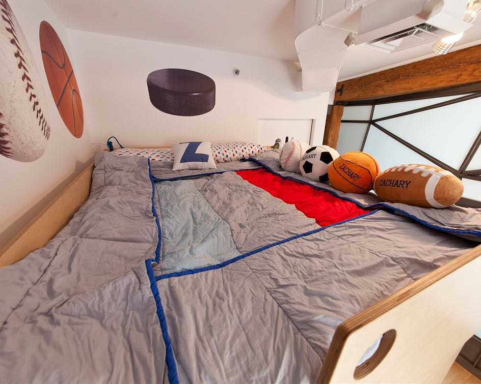 Child’s sports-themed bedroom with bunk bed and assorted balls.