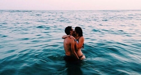 couple beach kissing