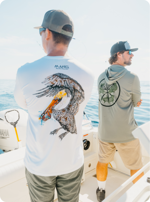 Keith Rossin of MANG Gear steering a boat with MANG Performance Longsleeve shirt and Hat