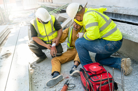 Workers providing first aid on a construction site