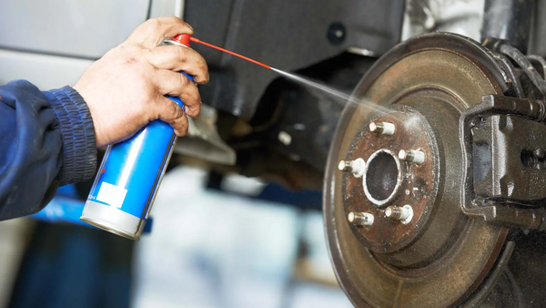 Spraying Cleaner on Brakes