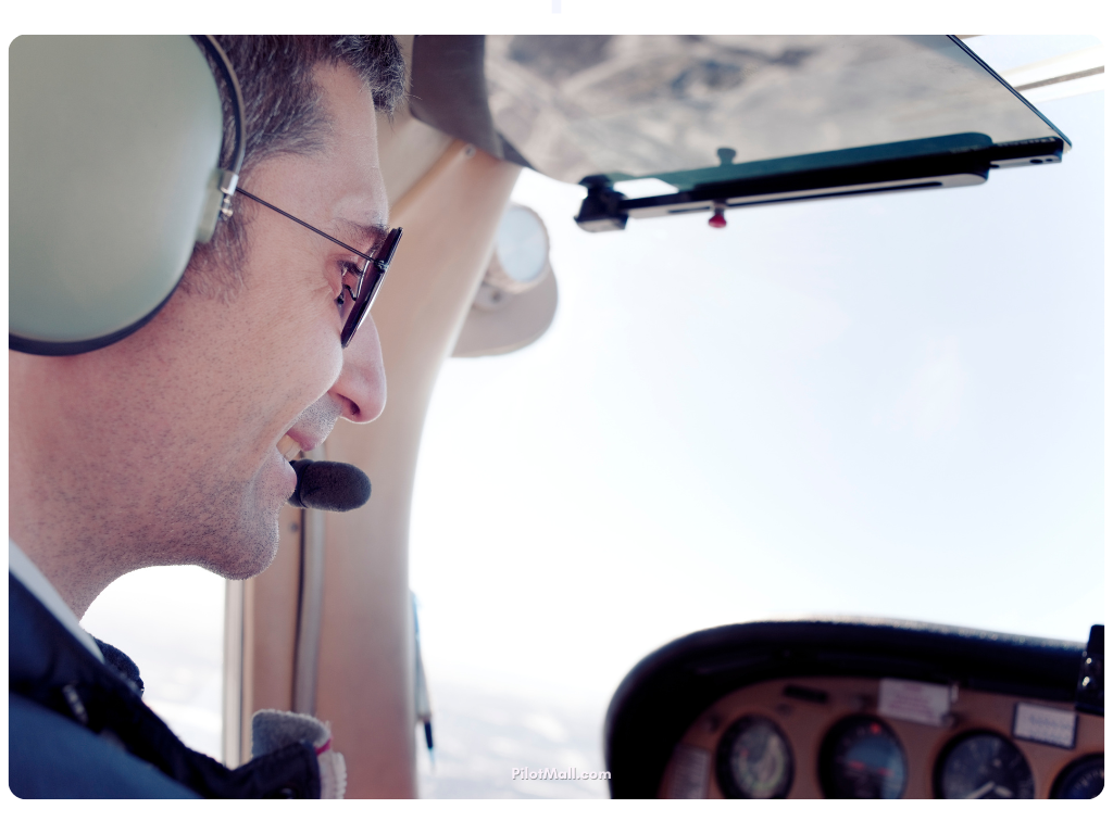 A pilot talking into their headset and looking pleased