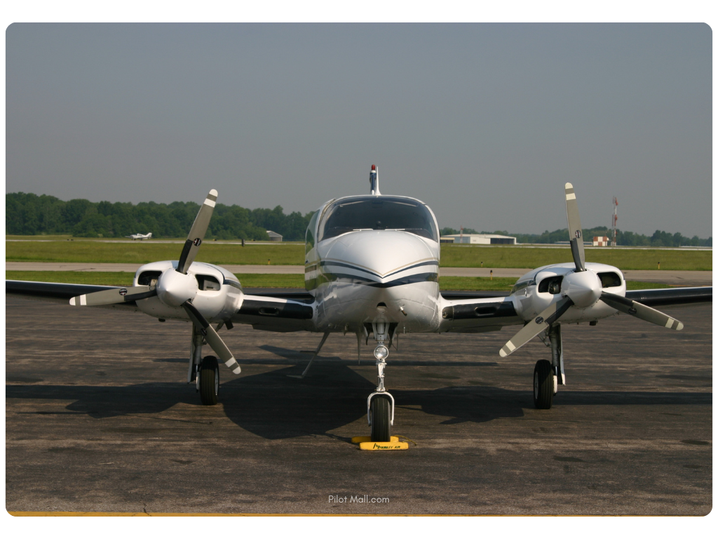 A twin engine aircraft parked on the tarmac - Pilot Mall