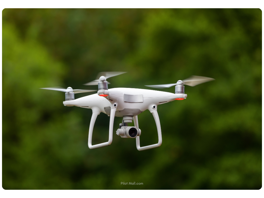 Closeup of a white drone flying with a small camera - Pilot Mall
