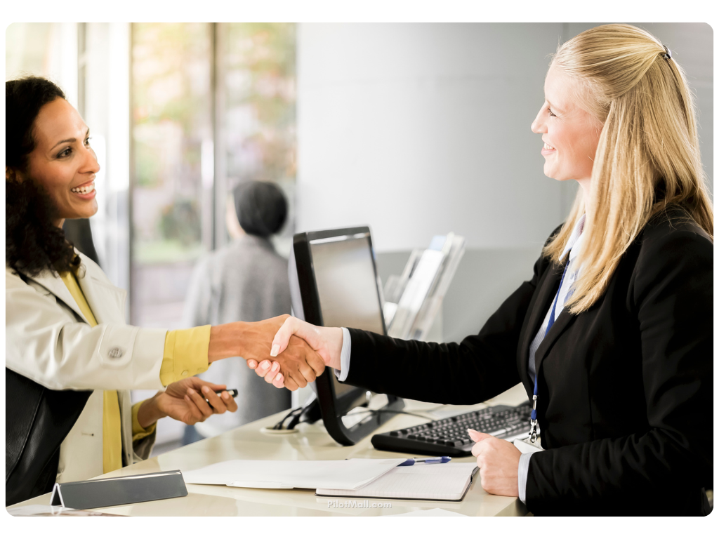 Customer and Bank Teller Shaking Hands - Pilot Mall