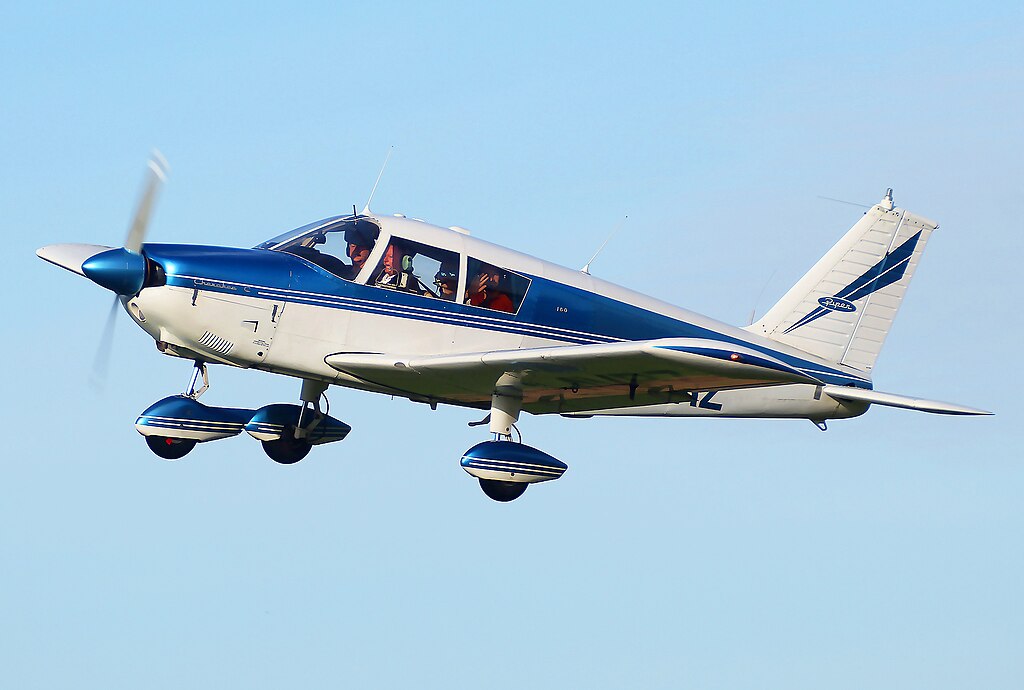 A Piper Cherokee Cruiser 140 PA-28-140 Flying in the Sky by Mike Burdett