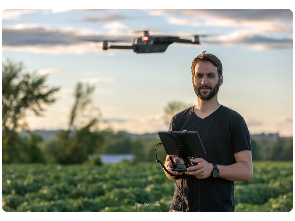 Man remote piloting a drone outside - Pilot Mall