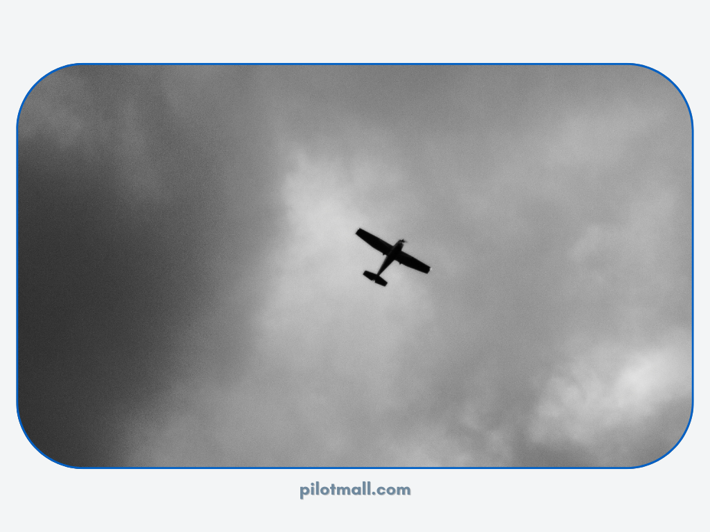 Single engine aircraft flying under dark clouds - Pilot Mall