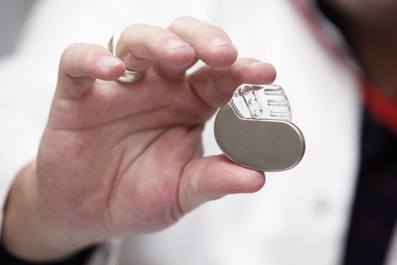Stock Image of a Doctors hands Holding a Pacemaker