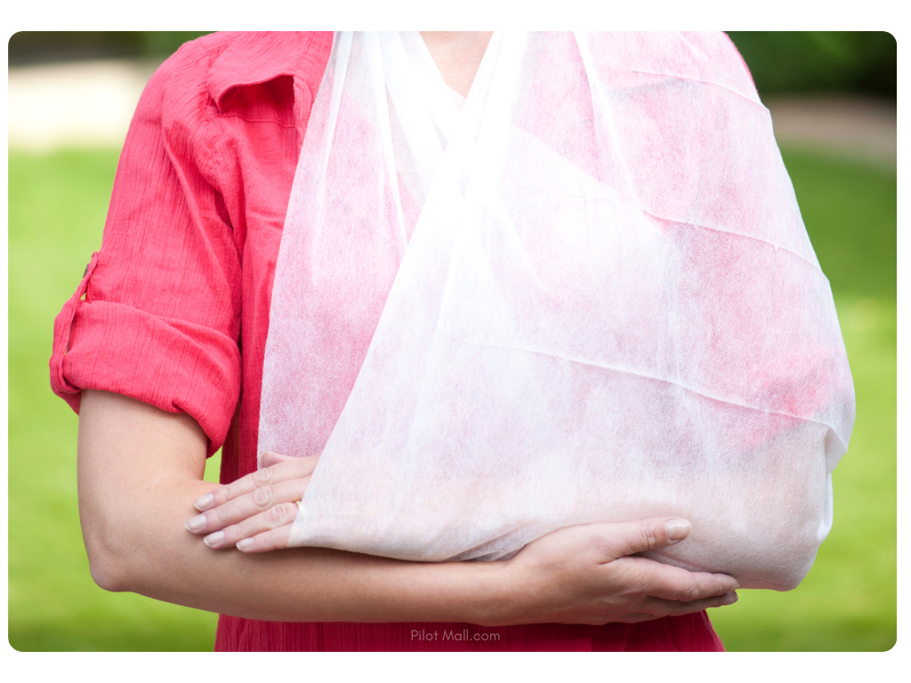 A woman with her arm in a triangular bandage sling