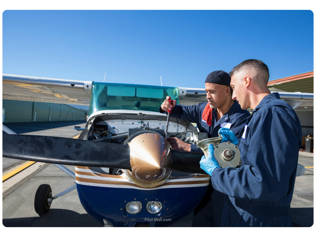 Two men working on a small aircraft engine - Pilot Mall