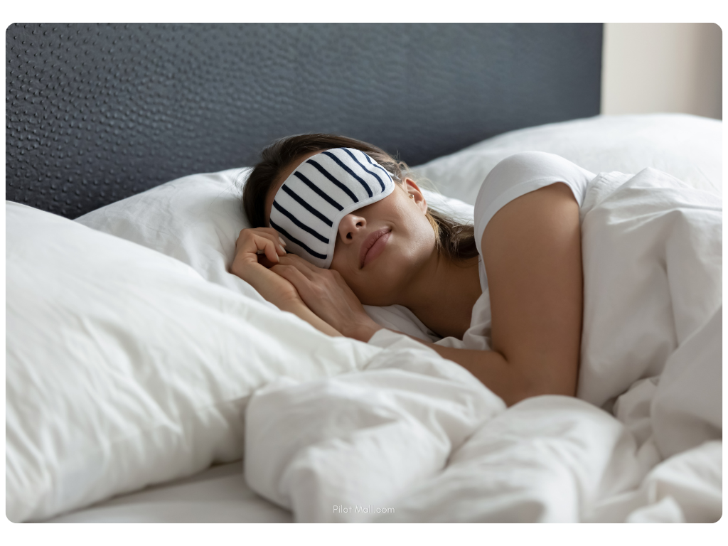Woman in bed wearing eye mask - Pilot Mall