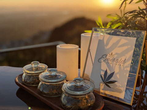Cannabis Bar Services with three jars of cannabis on a bar overlooking a gorgeous mountainous sunset