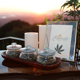 A cannabis bar displays weed in glass jars against a gorgeous California sunset