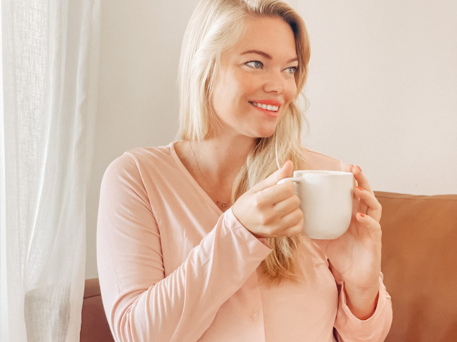 Pregnant mom in PJs drinking tea