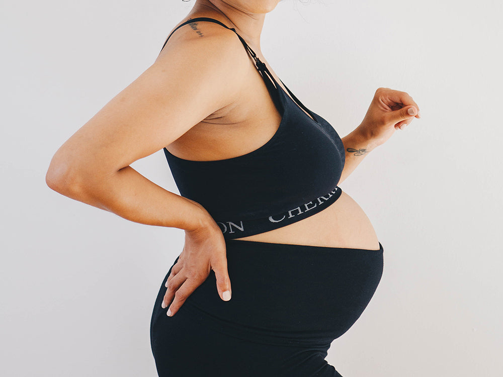 Baby bump photo or pregnant woman in Calvin Klein and Jean jacket