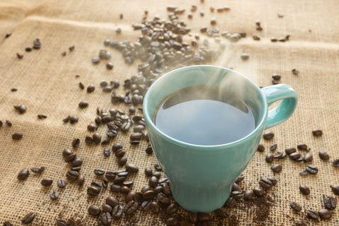 Coffee in mug with beans