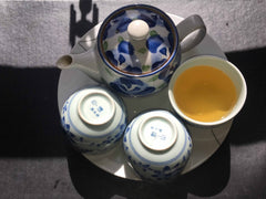 Teapot and cups with green tea