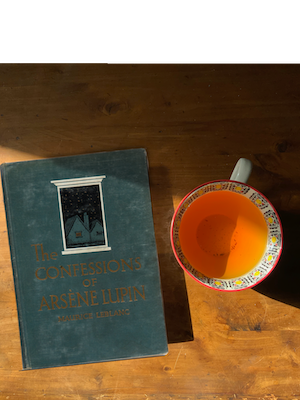 Luxurious Mint Chocolate Rooibos Green Tea next to "The Confessions of Arnese Lupin